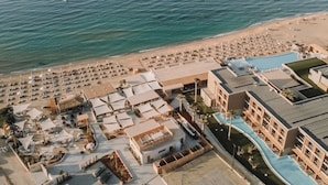 An aerial view of a resort with multiple buildings, a beach, and a swimming pool. - Cicada Theros Suite, with Private Pool, Gym, BBQ,  Beach & 5*Hotel Access
 (Heraklion)