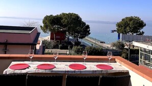 Ein Tisch für ein Essen mit Blick auf Meer und Bäume.