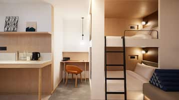 Une chambre compacte et moderne, équipée d’un lit superposé, d’un bureau et d’une chaise.