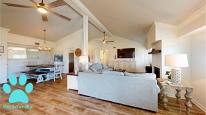 A pet-friendly living room with a sofa, dining table, and ceiling fans. - Chateau La Mer 16e-Pet Friendly! Close to the Beach~ Seasonal Beach Service! (Destin)