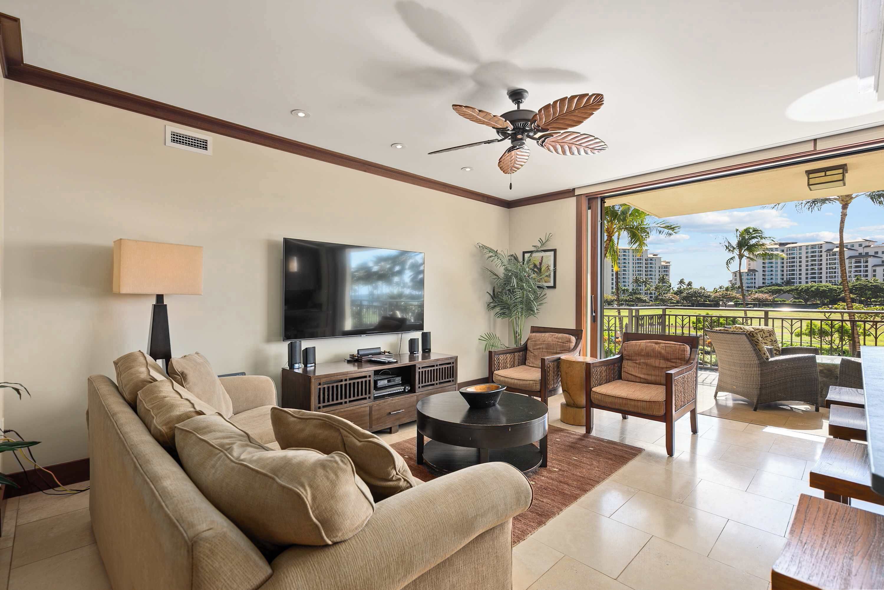 A modern living room with a sofa, TV, and dining area.