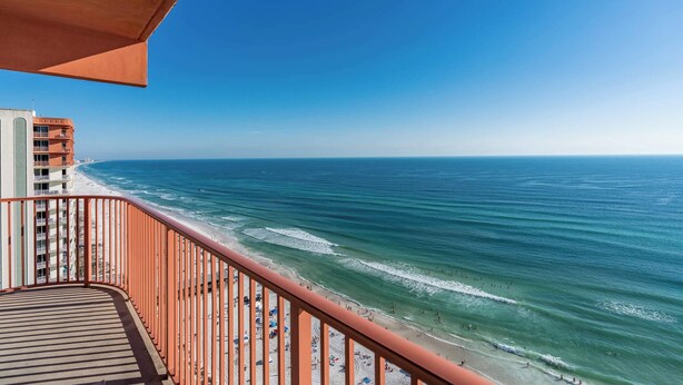 A balcony with a view of the beach and ocean. - Sunset Shores Oceanfront Condo Bliss (Panama City Beach)
