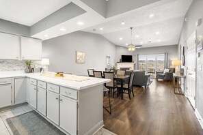 Enjoy meals in the spacious kitchen and dining area with a central island and large window offering a view of the outdoors.
