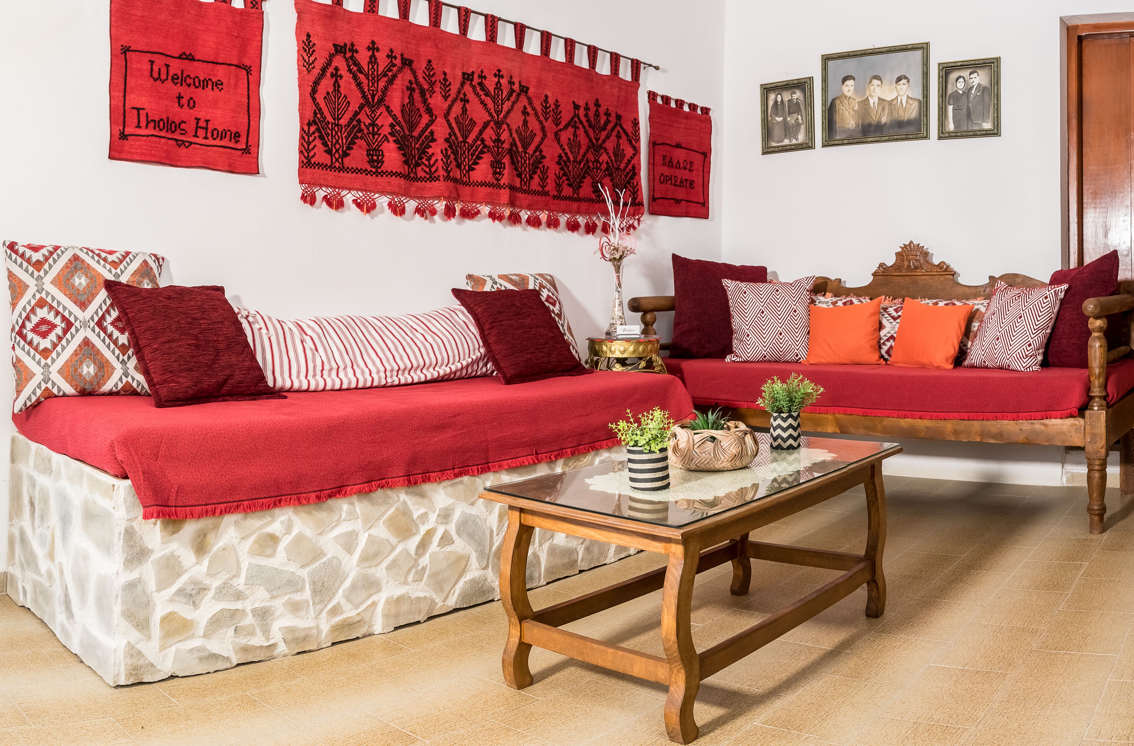 A living room with two sofas, a coffee table, and a stone-patterned bed.
