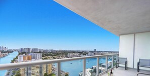 A high-rise building with a view of a marina and cityscape.