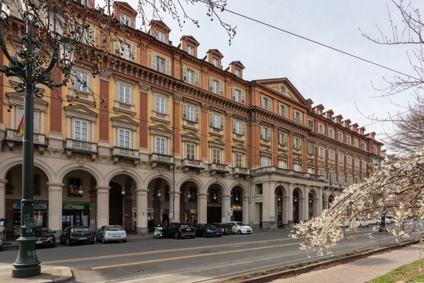 A multi-story building with a classical architectural style, featuring arched windows and a symmetrical facade.