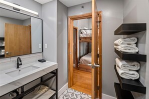 Bathtub, hair dryer, towels, shampoo