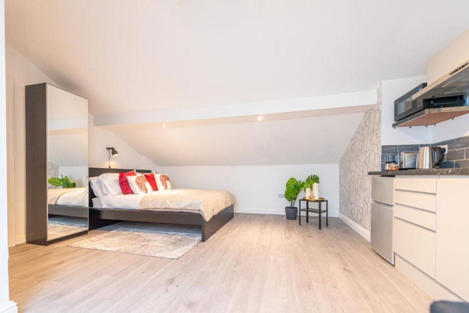 Desk, laptop workspace, iron/ironing board, bed sheets