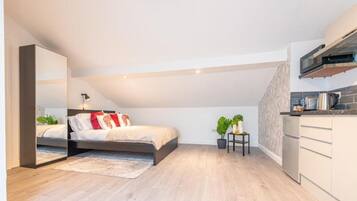 Comfort studio | Een bureau, een laptopwerkplek, een strijkplank/strijkijzer, beddengoed