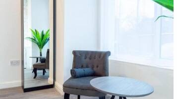 Desk, laptop workspace, iron/ironing board, bed sheets