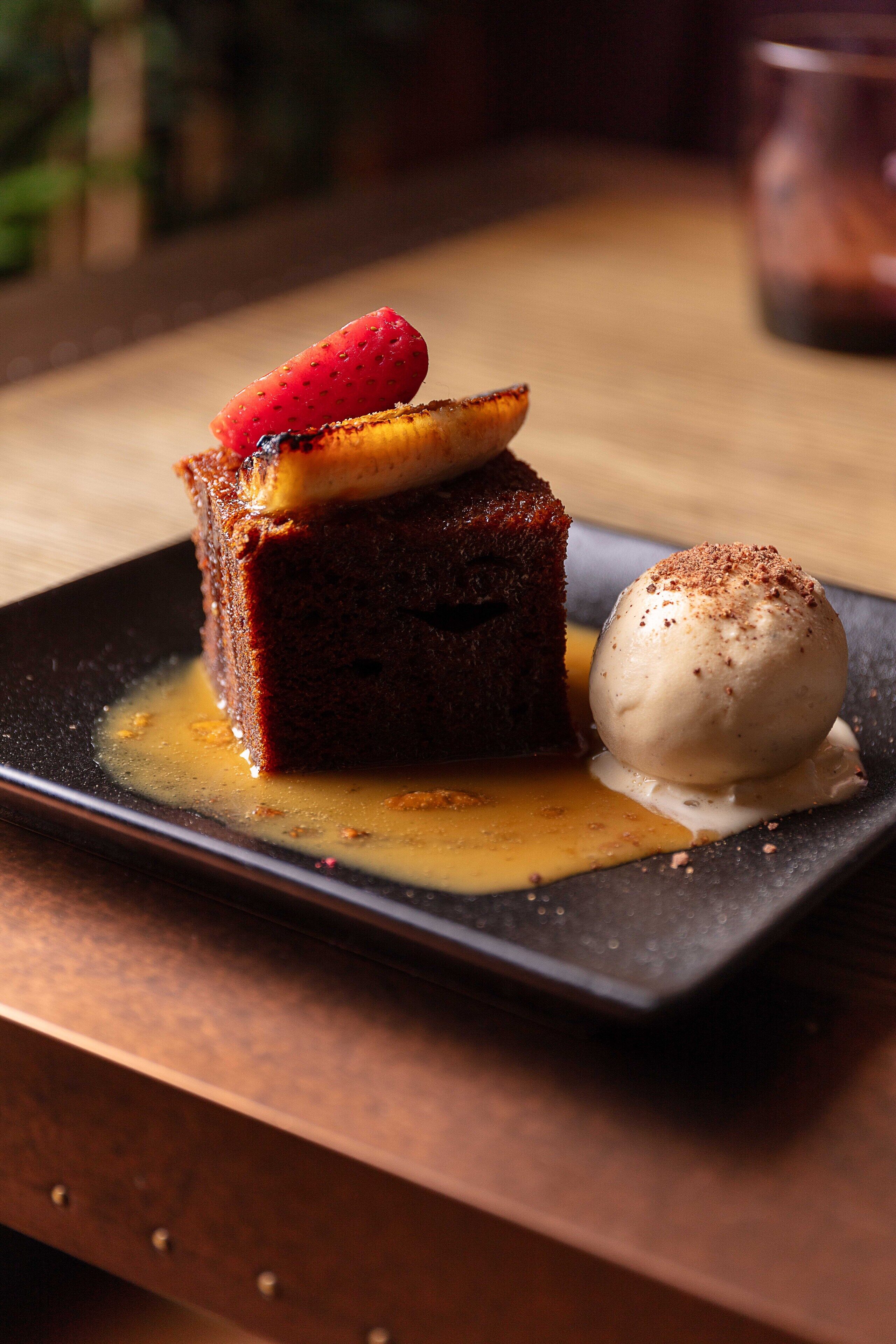 A dessert on a plate with a dark background.
