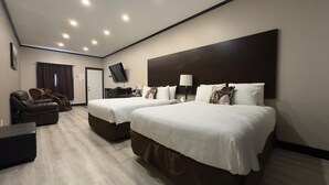 A hotel room with two beds, a massage chair, a TV, and a desk.