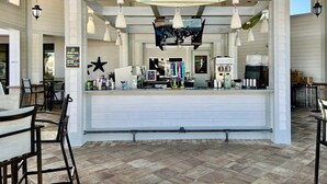 A restaurant with a counter, hanging lights, and a menu board. - Spacious Home With Fun Decore And Game Room-4544tb 8 Bedroom Home by RedAwning (Kissimmee)