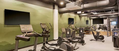 A gym with treadmills, stationary bikes, and weight machines.