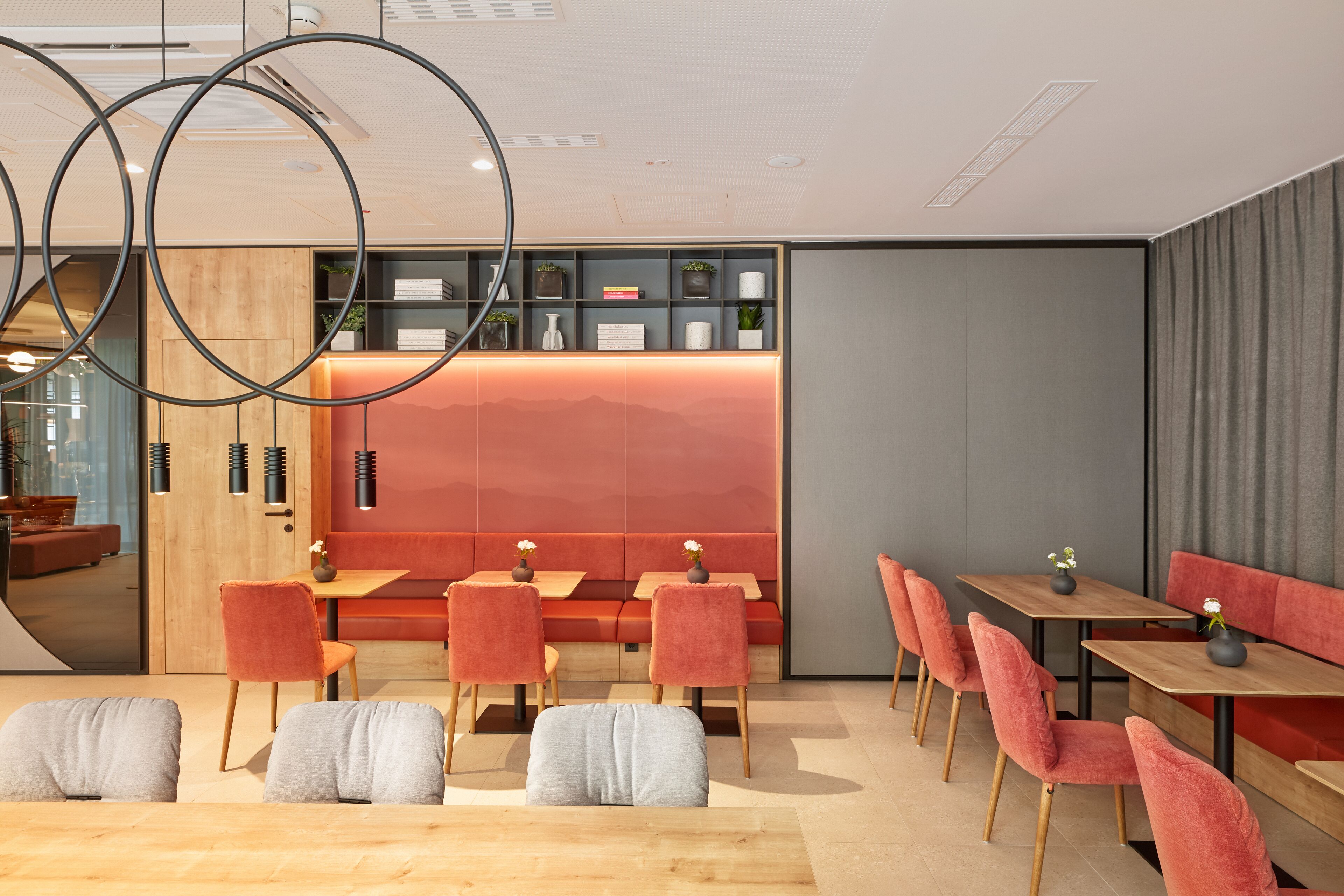 A modern interior with seating areas, a reception desk, and a view of the outdoors.