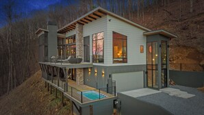 A modern two-story house with a balcony, large windows, and a stone facade. - Blue Ridge Ultra Luxury with Stunning Mountain & Lake Views, Near Aska & Marina (Blue Ridge)