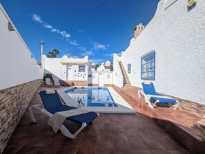 A poolside area with a pool, lounge chairs, and a staircase leading to a building. - Traditional Villa with Private Pool SM591 (San Miguel de Salinas)