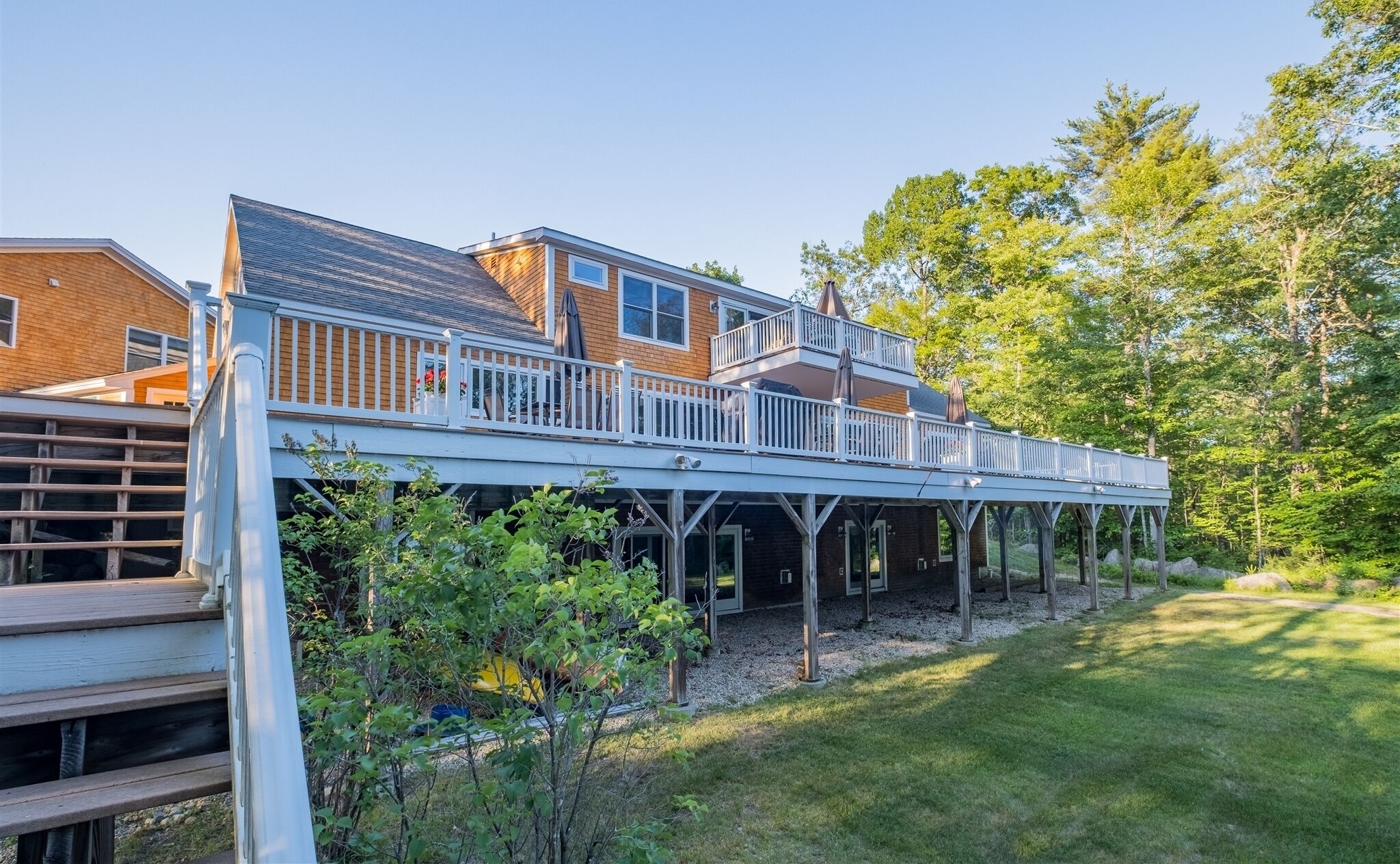 A two-story house with a covered patio area.