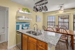 Enjoy cooking in this well-equipped kitchen with a dishwasher and dining area.