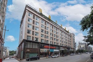 A multi-story hotel with a flat facade, large windows, and a visible entrance with signage.
