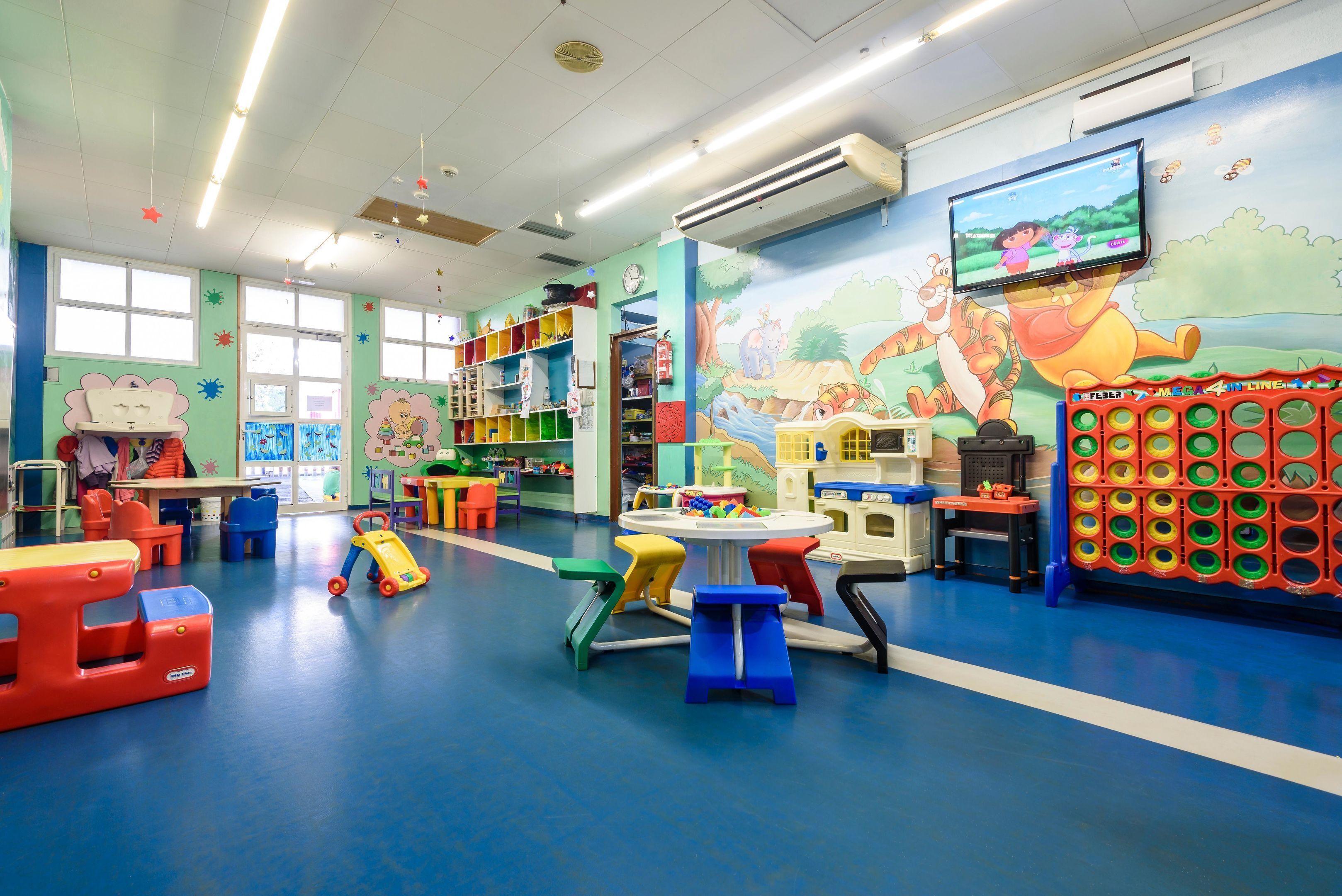 A brightly colored indoor play area with various toys and furniture.