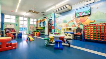 A brightly colored indoor play area with various toys and furniture.