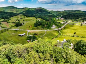 A rural landscape with rolling hills, a winding road, and scattered buildings. - Mountain Views at Dolly's Castle Unit 5 (Sevierville)