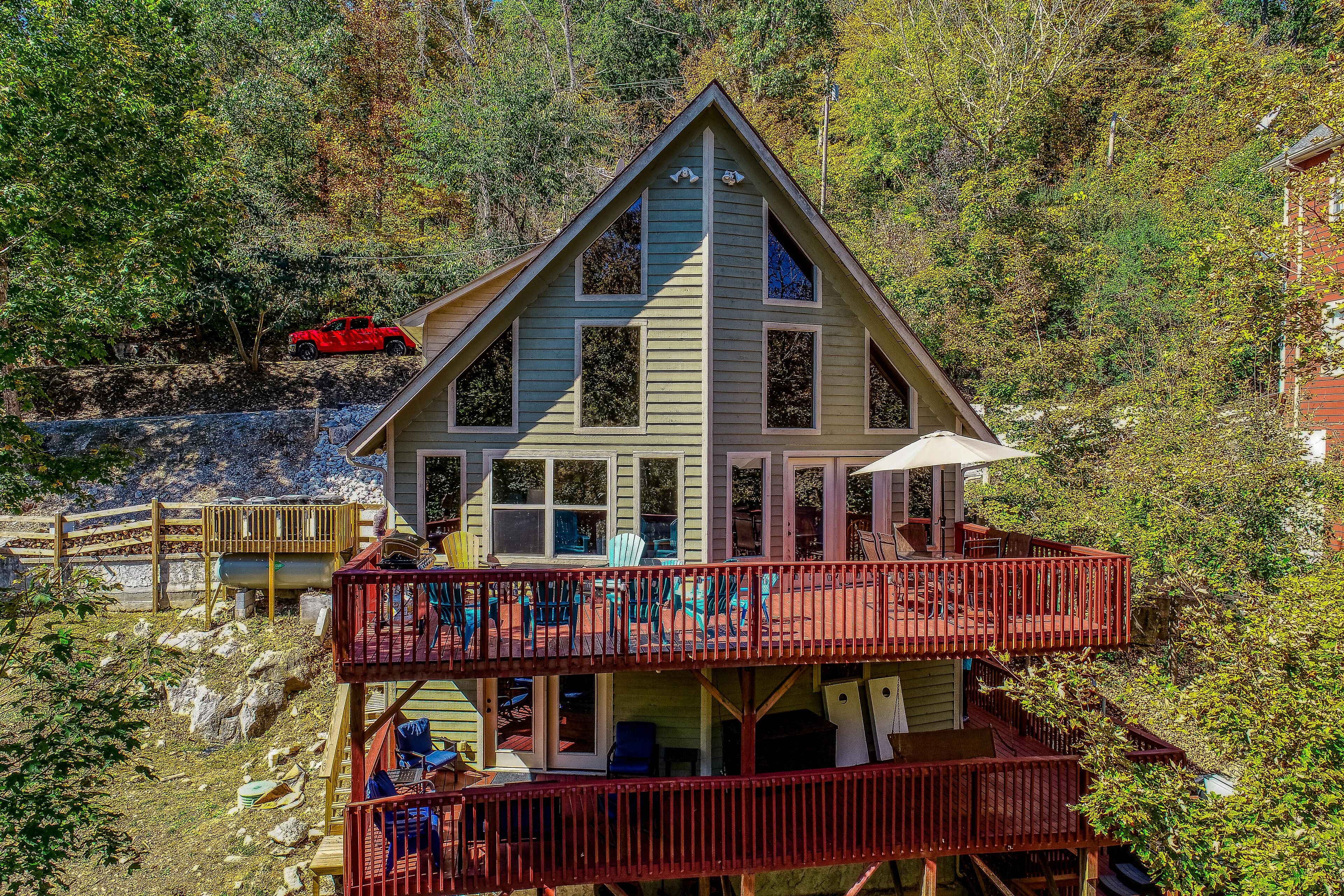 Rustic lakefront retreat with a hot tub, double-deck dock, firepit, grill & deck