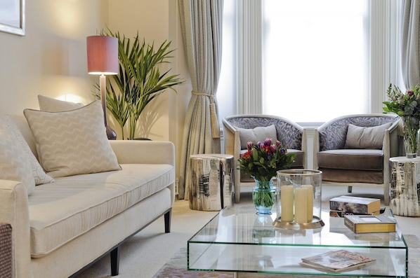Relax in this stylish living room with a comfortable sofa, coffee table, and decorative accents.