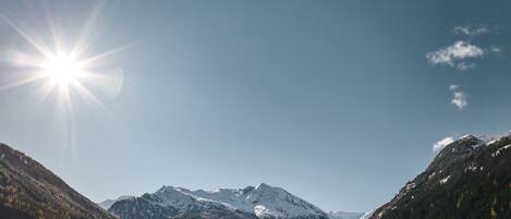 A mountainous landscape with snow-covered peaks and a clear sky.