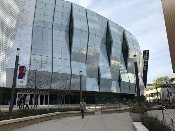 A modern building with a glass facade and a sign reading "Golden Center."