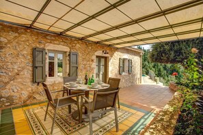 Enjoy a romantic dinner for two on this patio, complete with a round table and comfortable seating.