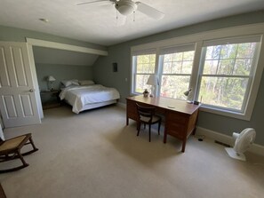 A bedroom with a bed, a desk, and a chair. - Solar-eV Country Home - Quaint Cazenovia! (Cazenovia)
