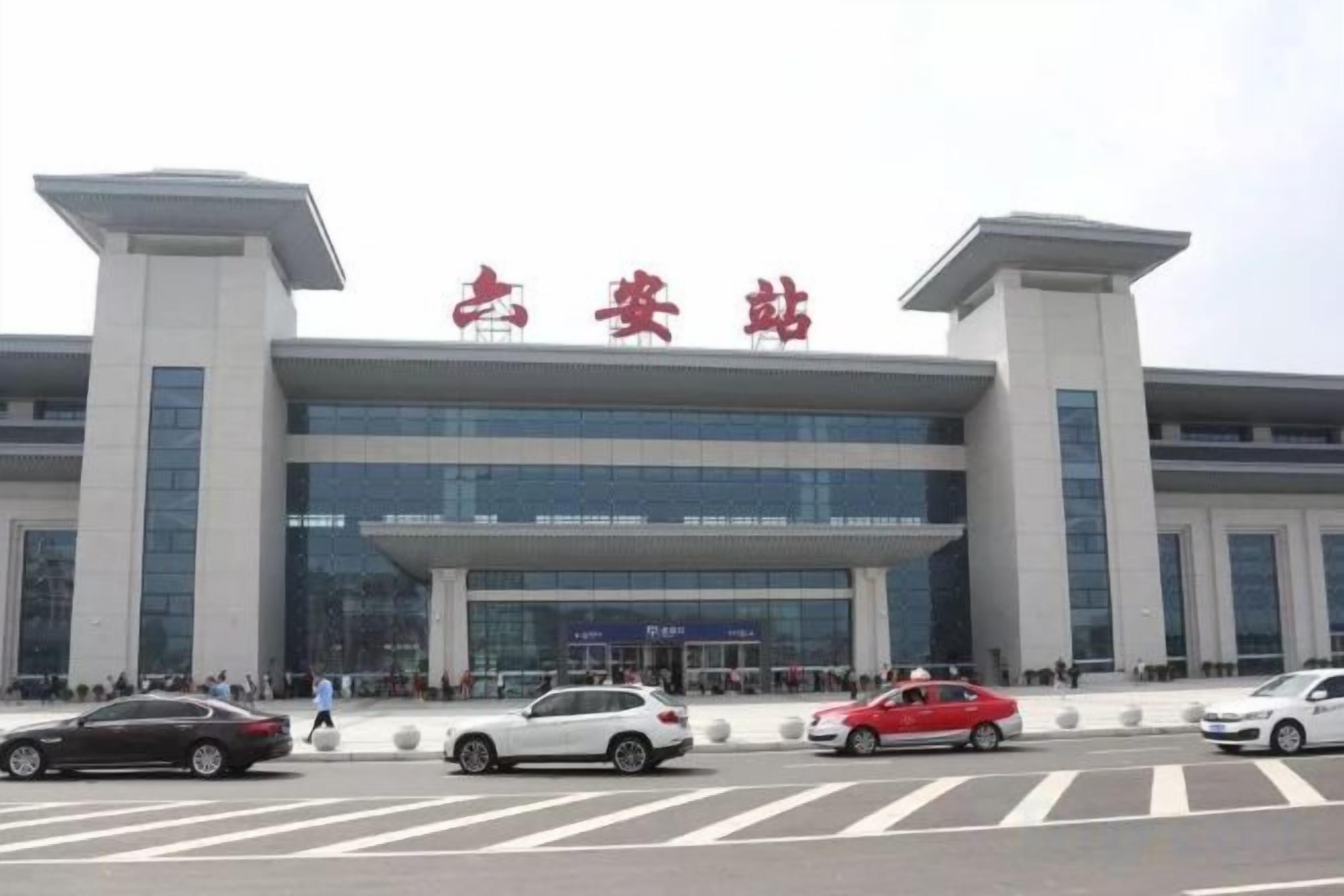 A modern building with a prominent entrance and a large sign above.