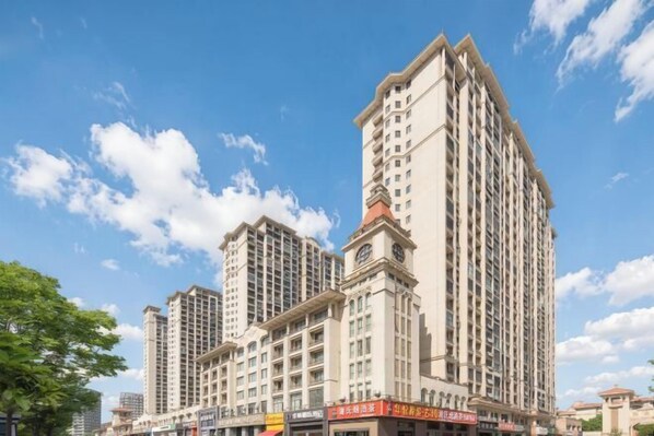 A multi-story hotel with a prominent corner entrance, large windows, and a flat roof. - Home Inn Huaxuan Collection (Lu'an High-speed Railway Station) (Lu'an)