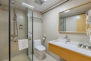 A bathroom with a glass shower enclosure, a toilet, a sink with a mirror, and a towel rack. - Home Inn Huaxuan Collection (Lu'an High-speed Railway Station) (Lu'an)