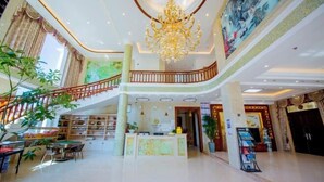 A spacious lobby with a grand chandelier, a staircase, and a reception desk. - Lanting Holiday Villa (Putian)