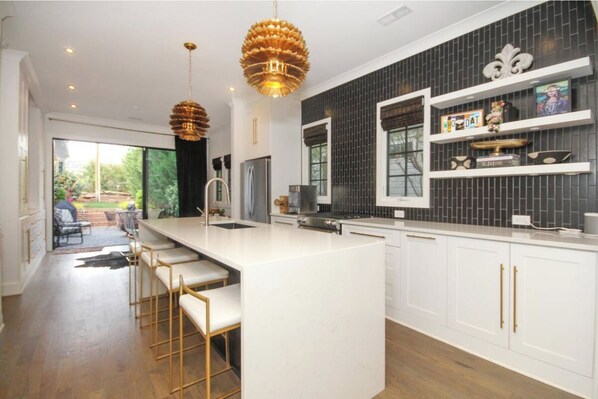 Enjoy cooking in this well-lit kitchen with a large island and bar stools.