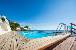 A heated pool, pool loungers