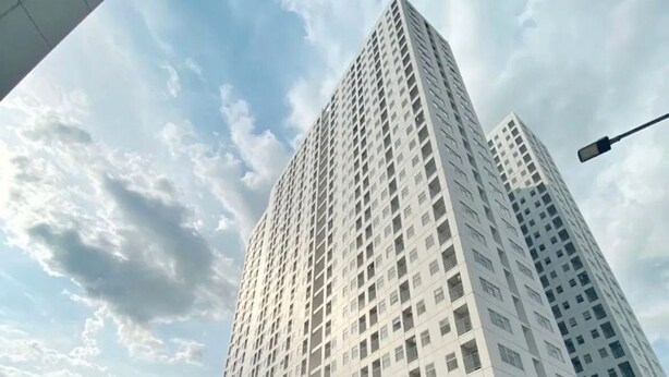 A tall, modern building with a geometric sculpture in front. - Serpong Garden Apartment by Kakarama (Cisauk)