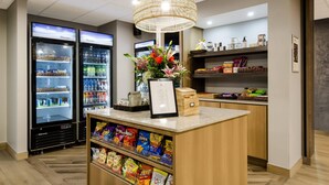 A snack bar with a variety of chips and a beverage cooler.