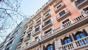 A multi-story building with balconies, large windows, and classical architectural details. - P2PAR1002- Super Bright & New 2B Apt in the center (Barcelona)