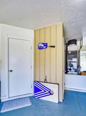 A room with a white door, a blue and white patterned mat, a blue and white striped wall, and a shelf with items. - SALT Pool, Golf, Master Suite, Near Sandy Beaches (Rotonda West)