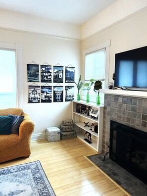 Relax in this inviting living room with a comfortable sofa, flat-screen TV, and fireplace.