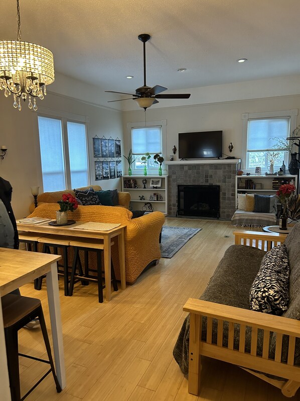 Cozy living space with a fireplace, television, and dining area.