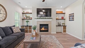 Smart TV, fireplace, books, printers