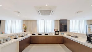 A modern kitchen with a central island, a coffee machine, and a microwave. - Jinjiang Inn (Shanghai International Tourist Resort Kangxin Highway) (Shanghai)