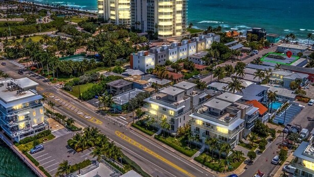 A coastal urban area with modern buildings, a marina, and a prominent hotel with multiple floors and balconies. - 1BR Getaway by Dania & Hollywood Beach (Hollywood)