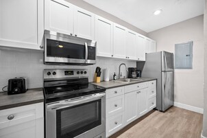 Premium 2-Bedroom Family Suite w/ Kitchen & Sofa Bed | Private kitchen | Full-size fridge, microwave, oven, stovetop