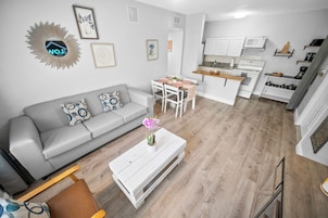 Deluxe 1-Bedroom Queen w/ Kitchen & Sofa Bed | Living area | 50-inch Smart TV with digital channels